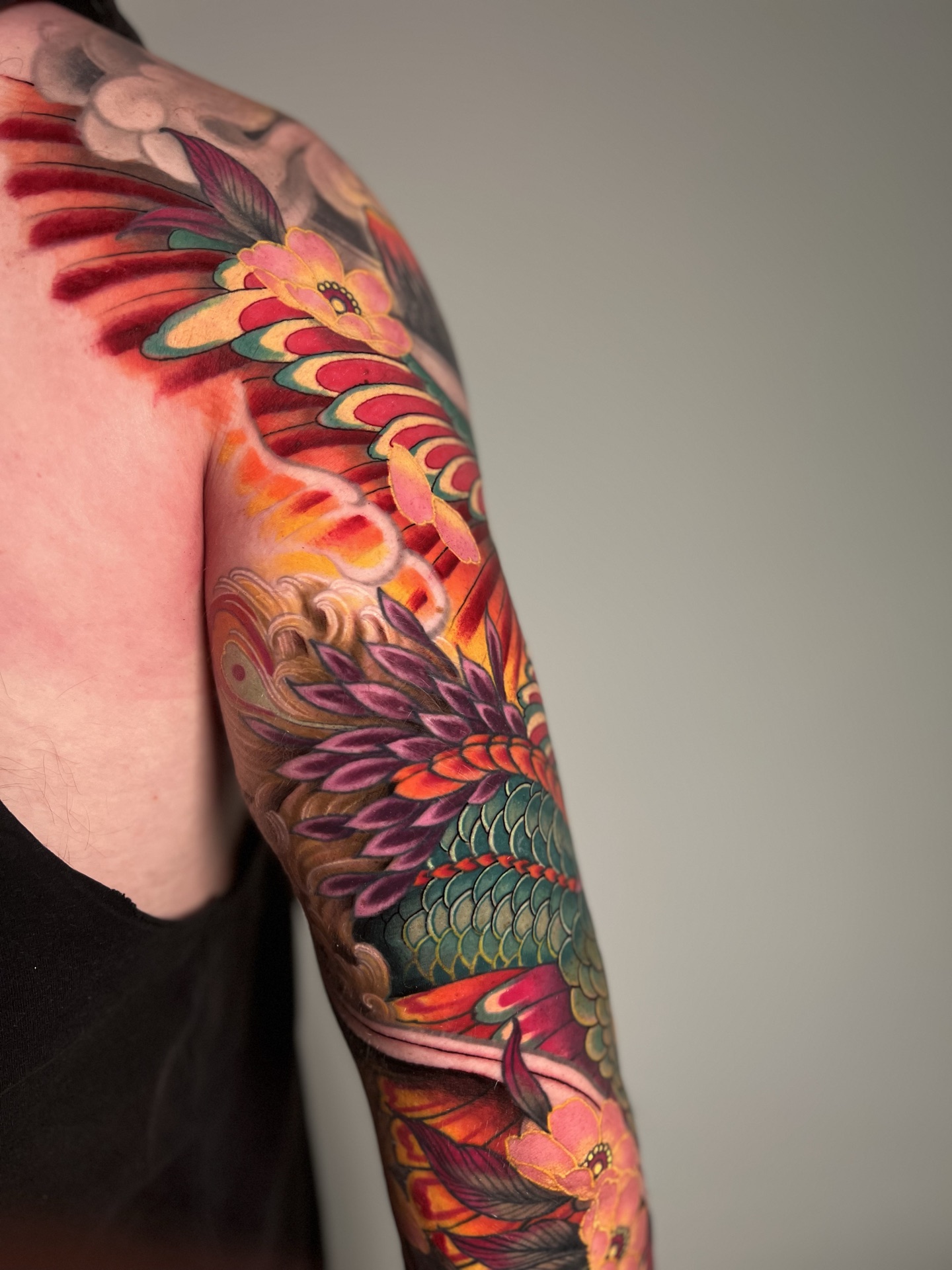 Phoenix wing colour sleeve tattoo by Levi Taylor